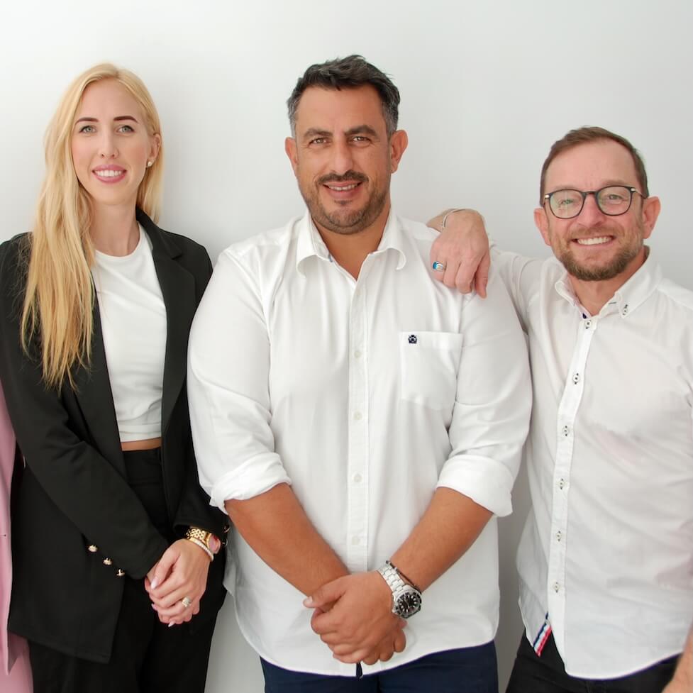 A group photo of four Realty Connect CY team members, a real estate agency in Paphos, Cyprus, standing together and smiling.